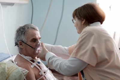 Nurse fixing oxygen mask respiratory therapy rehab nursing care brooklyn rehabilitation home new york