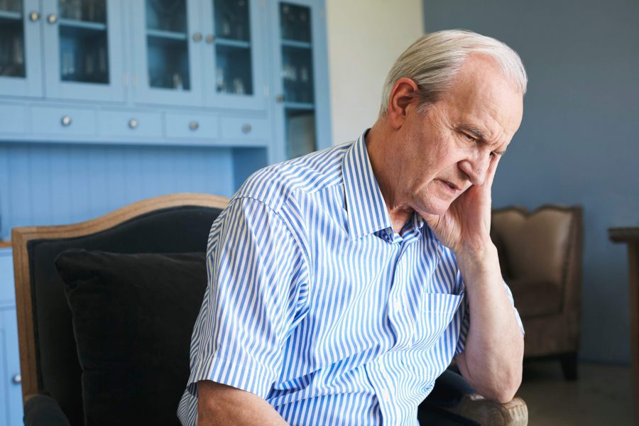 Elderly man sitting and worried about how to stop cognitive decline