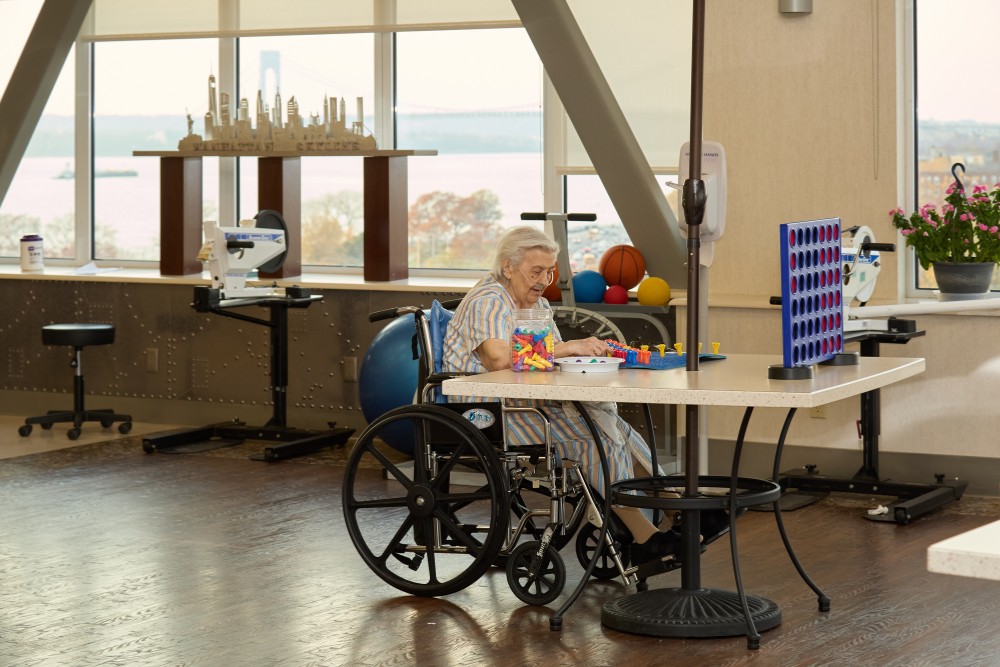 Senior woman in a wheelchair engaging in cognitive activities, highlighting therapy for ADHD and dementia in older adults.